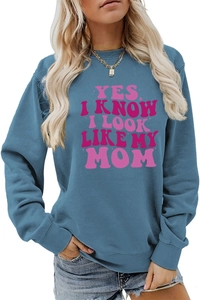 Detail of blue long-sleeve sweatshirt featuring pink Yes I Know I Look Like My Mom text