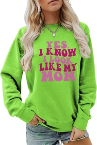 Detail of neon green crewneck sweatshirt featuring pink slogan letter printing