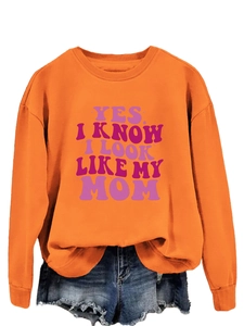 Detail of orange long sleeve sweatshirt with purple YES I KNOW I LOOK LIKE MY MOM print