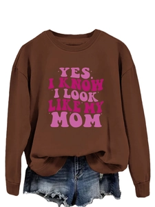 Detailed view of brown crewneck sweatshirt with pink retro Yes I Know I Look Like My Mom text