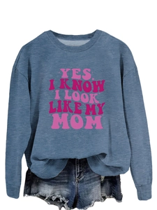 Detail of grey blue sweatshirt with pink YES I KNOW I LOOK LIKE MY MOM print and denim shorts