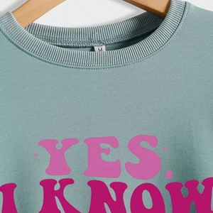 Green long sleeve sweatshirt with pink Yes I Know text print and ribbed crew neck