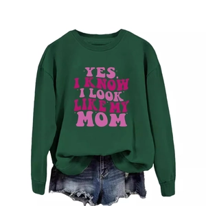 Dark green crewneck sweatshirt with pink text print paired with denim shorts