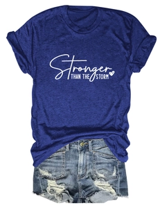 Flat lay detail of blue cotton t-shirt with Stronger text and distressed denim shorts