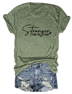 Flat lay of army green graphic t-shirt with denim shorts and street style details