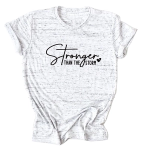 Detail of Stronger Than The Storm text print on heather white cotton t-shirt fabric