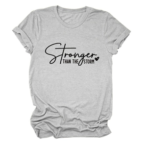 Detail of Stronger Than The Storm text print on light grey casual cotton t-shirt