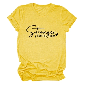 Detail of yellow cotton T-shirt featuring Stronger Than The Storm text and heart graphic