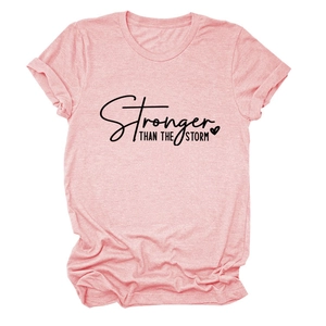 Close-up of Stronger Than The Storm text and heart print on pink heather cotton t-shirt