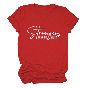 Close-up of Stronger Than The Storm lettering on a red crewneck cotton T-shirt