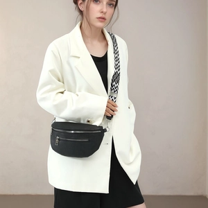 Minimalist black crescent crossbody chest bag with geometric wide woven shoulder strap