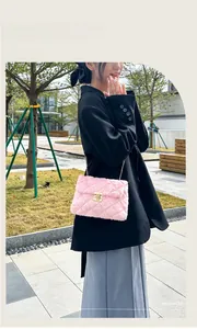 Detail of pink faux fur crossbody bag with quilted pattern and gold twist lock