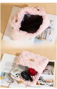 Detail view of pink plush crossbody bag showing interior capacity with phone and accessories