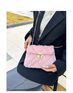 Detail of pink faux fur crossbody bag with diamond quilting and gold chain strap