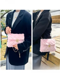 Detailed view of pink faux fur crossbody bag with quilted pattern and gold chain strap