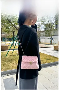 Detail of pink faux fur square crossbody bag with diamond quilting and gold metal lock