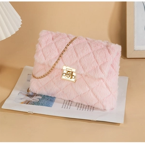 Detail of pink faux fur crossbody bag with quilted pattern and gold metal chain strap