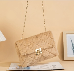 Detail of plush crossbody bag featuring faux fur texture and gold chain strap lock