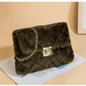 Detail of dark brown faux fur bag with diamond texture and gold chain strap