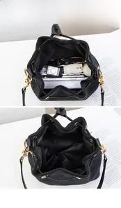 Macro view of black suede bucket bag showing large capacity for phone and wallet
