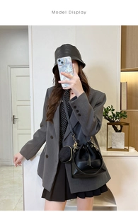 Fashionable black faux leather drawstring bucket bag with mini coin purse shown on model