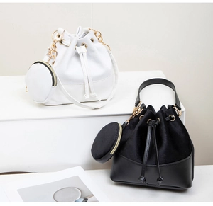 Detail of drawstring bucket bag with suede texture and gold hardware accessories