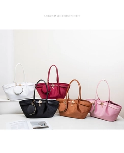 Detail view of colorful suede tote bag sets with swan charm and matching coin purse