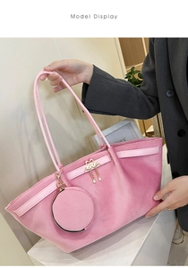 Pink suede tote bag detail with golden flamingo charm and round coin purse attachment