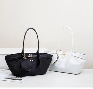 Chic tote bags in black and white featuring gold swan pendants and round coin purses