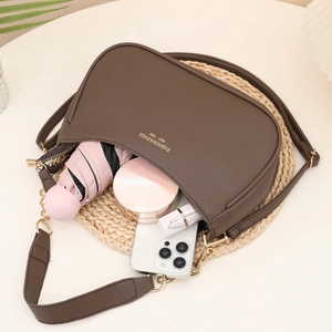 Deep brown lychee texture shoulder bag with gold lettering and adjustable strap