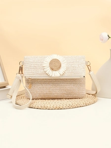 Detailed macro of woven straw bag texture featuring large white fabric daisy ornament