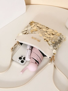 Detail of beige sequin crossbody bag showing capacity for phone, lipstick, and folding umbrella