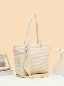 Detail of beige woven tote bag with matching leather pouch and refined texture