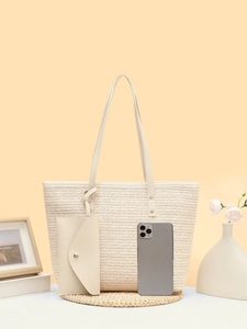 Detail of woven tote bag and clutch set in light beige with smartphone for size reference