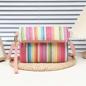Colorful striped woven crossbody bag with pink PU strap and golden metal hardware details