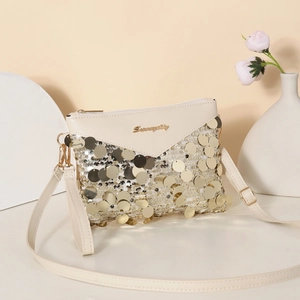 Elegant cream sequin crossbody bag with gold disc embellishments and stylish envelope flap