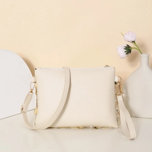 Minimalist beige leather crossbody bag with golden hardware and sequins in soft studio setting