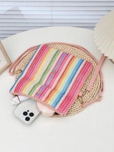 Top view of striped woven crossbody bag with phone and makeup inside for daily storage