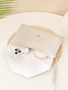 Silver crocodile texture clutch with magnetic closure and wristlet strap detail