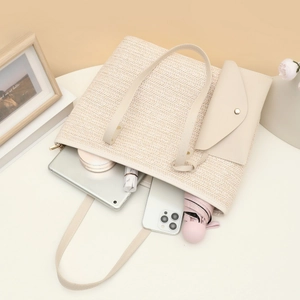 Minimalist beige woven tote bag and pouch set with textured pattern and gold clasp