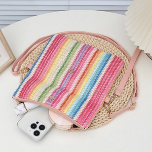 Women's woven rainbow shoulder bag with pink leather strap and spacious interior