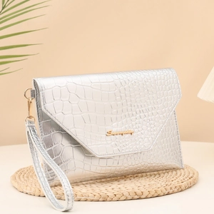 Silver crocodile texture clutch bag with gold letter logo and wrist strap detail