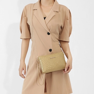 Fashionable champagne gold textured crossbody bag with gold chain strap and wristlet