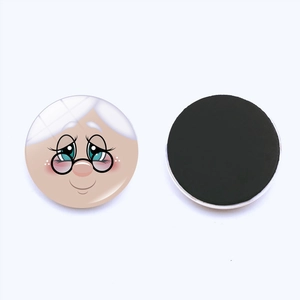 Detail of round Christmas snowman fridge magnet showing front cartoon and back magnetic layer