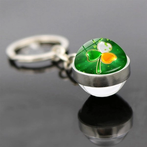 Macro shot of Ireland flag shamrock glass cabochon pendant with silver metal keychain