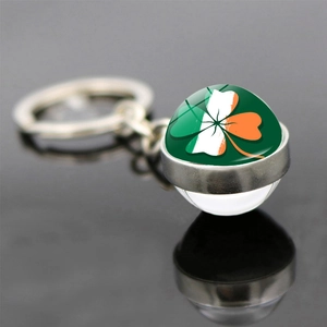 Macro detail of Ireland shamrock flag keychain with glass dome and lucky clover motif