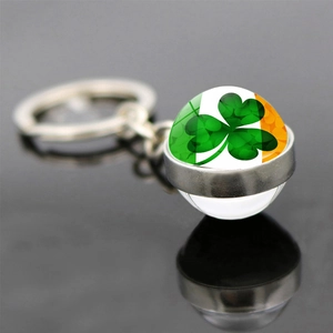 Double-sided glass ball keychain with Irish flag stripes and a green lucky shamrock clover