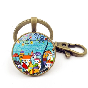 Porte-clés en bronze avec illustration colorée peinte à la main d'un paysage urbain