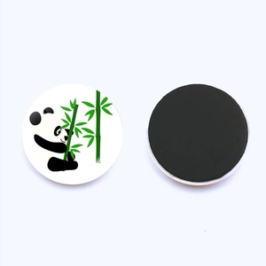 Macro detail of round panda fridge magnets showing crystal glass surface and black magnetic back