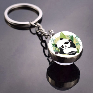 Detail of cute panda metal keychain with double-sided glass pendant and bamboo design